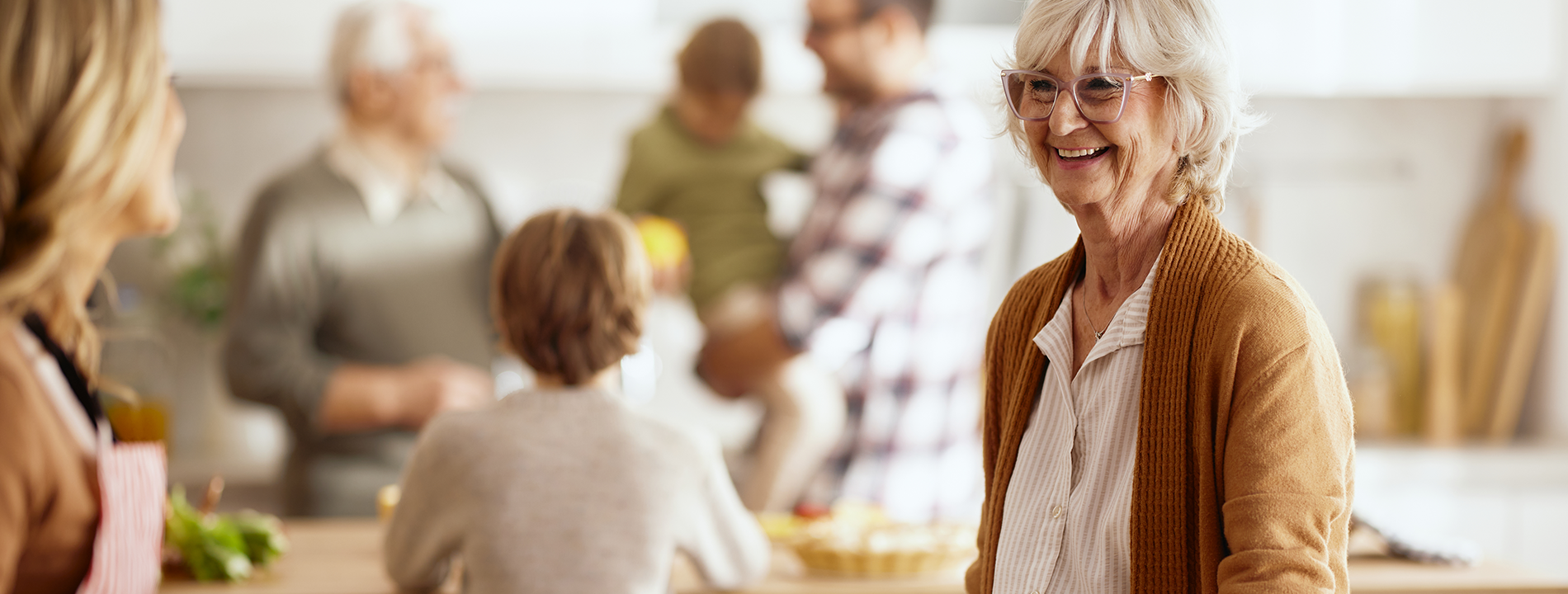 Mature woman with family in kitchen image