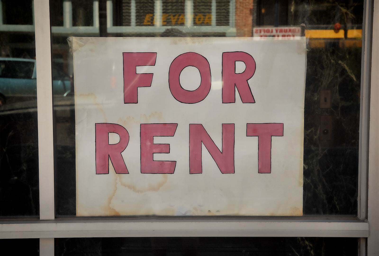 a for rent sign in a store window